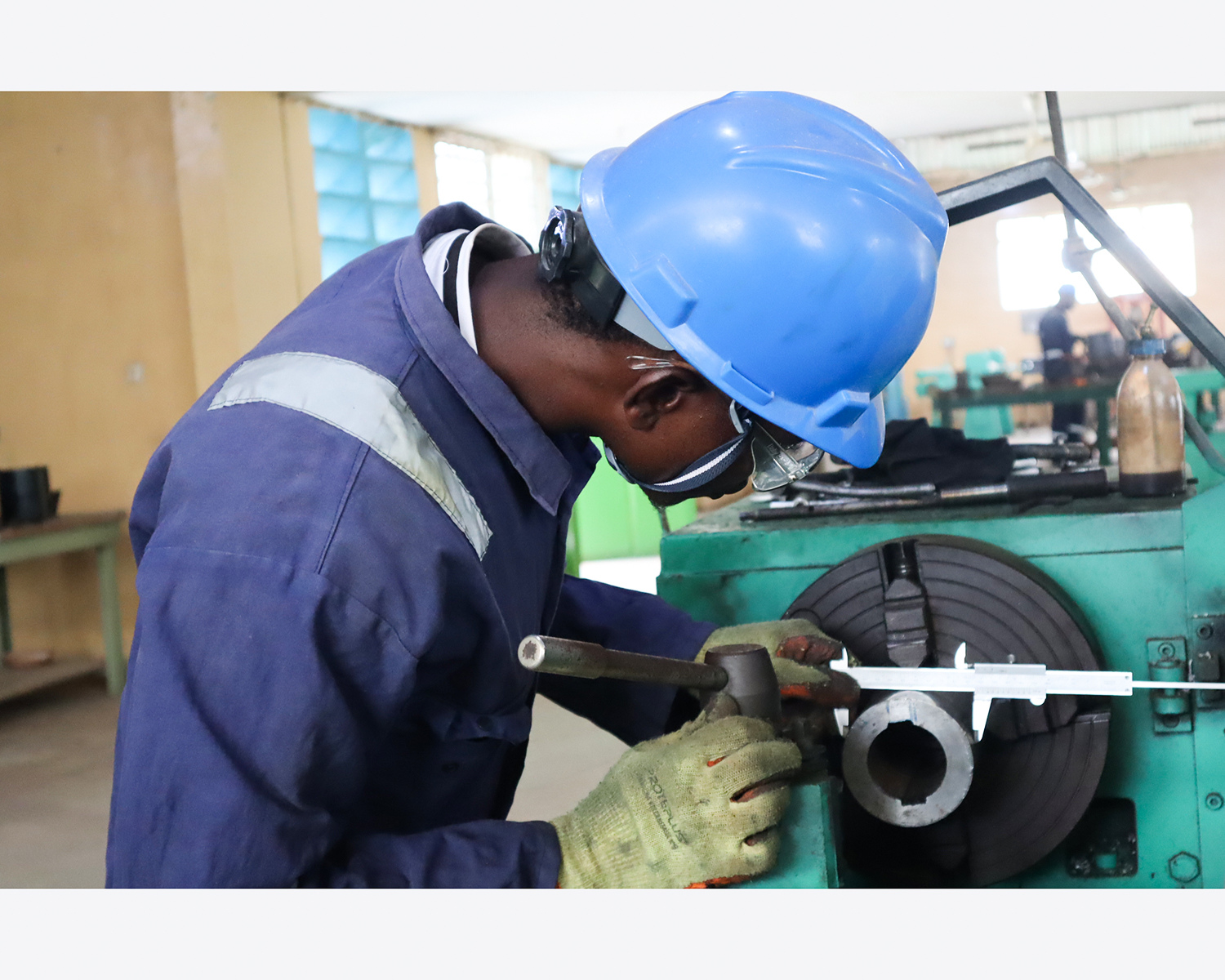 ESTA trainee operating machining equipment in the workshop